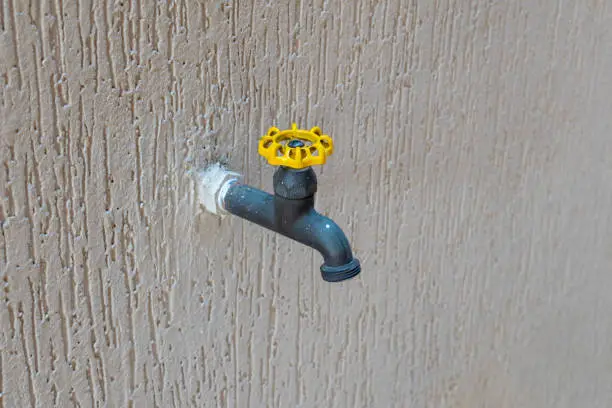 Photo of tap isolated on grafiato wall. selective focus