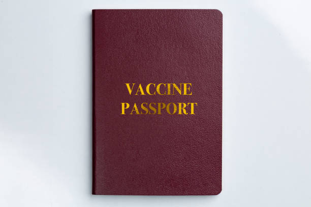 istock covid 19 Vacine passport certificate book on white background 1359755147