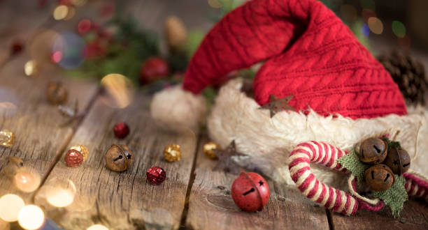 Santa Hat with Christmas Bokeh Lights on a Rustic Wood Background