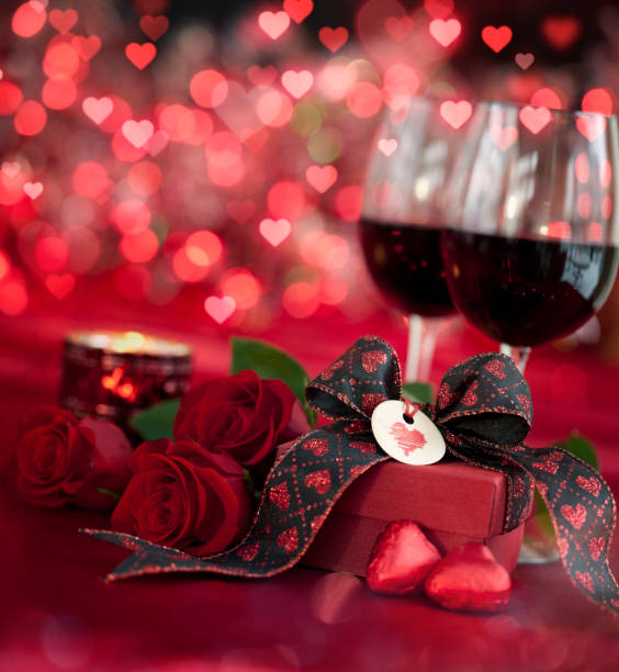 istock Valentine's Day Red Roses and Red Wine on a Defocused Lights Background 1359756938