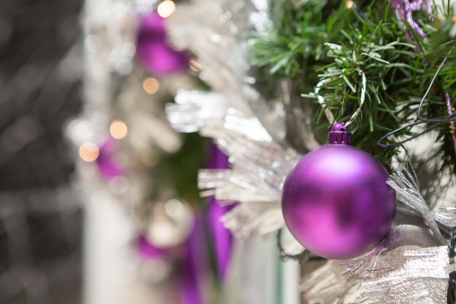 Selective focus of Purple balls on a Christmas tree decorated in Christmas and New Year's Day