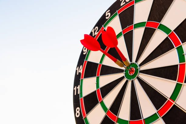 istock Dart arrow hit center on bullseye dartboard is target 1359764201