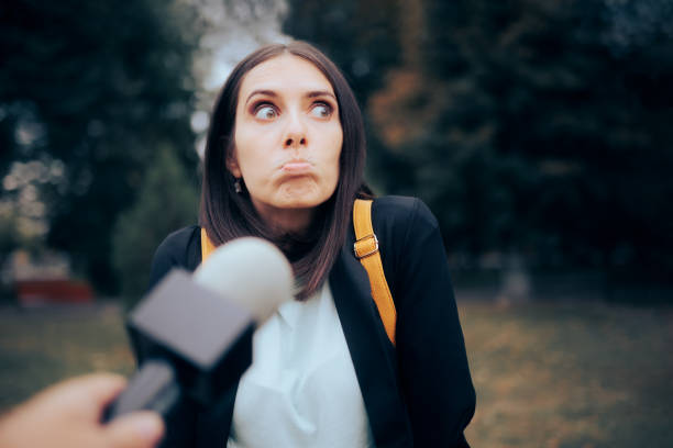Woman Not Knowing the Answer to Street Interviewer Question Woman being interviewed by a reporter in vox pop video format interrogation woman stock pictures, royalty-free photos & images