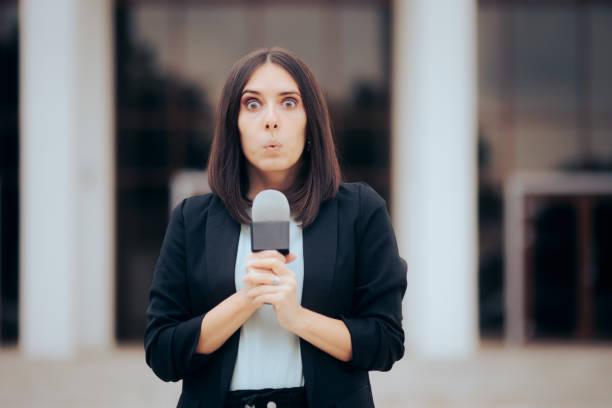istock Surprised Reporter Holding a Microphone Ready to Broadcast 1359768935