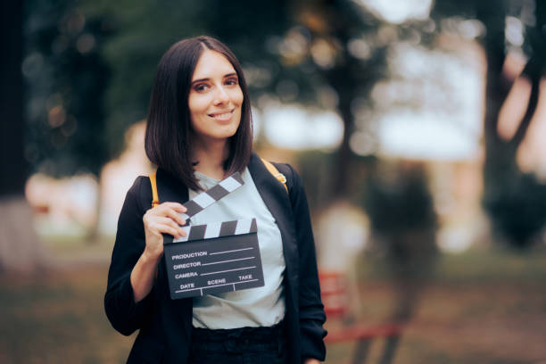 Woman Holding Film Slate Taking Acting Classes Student actor rehearsing her role performing outdoors actress audition stock pictures, royalty-free photos & images