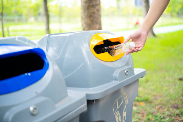 istock Close up hand throwing empty plastic bottle into the trash Recycling Concept 1359778002
