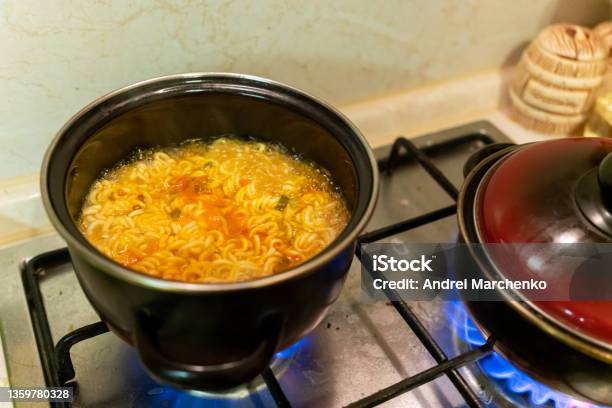 Instant Noodles In A Saucepan Are Cooked On A Gas Stove Closeup Stock Photo - Download Image Now