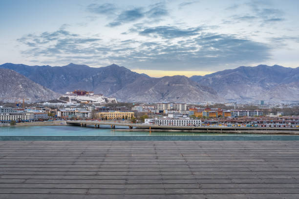 Lhasa scenery, distant view of Potala Palace with wooden floor foreground, Tibet Autonomous Region, China.