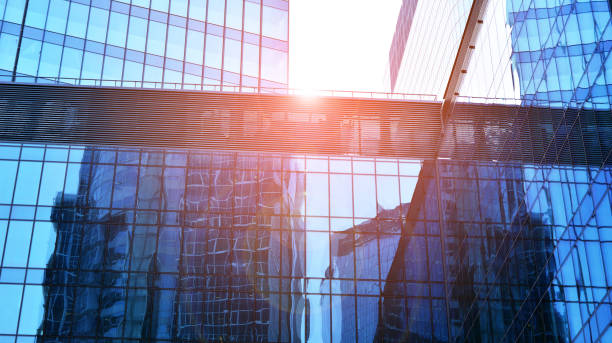 istock Modern office building with glass facade on a clear sky background. 1359781370