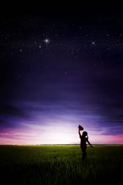 istock Evening sunset with a child flying a paper airplane 1359782093