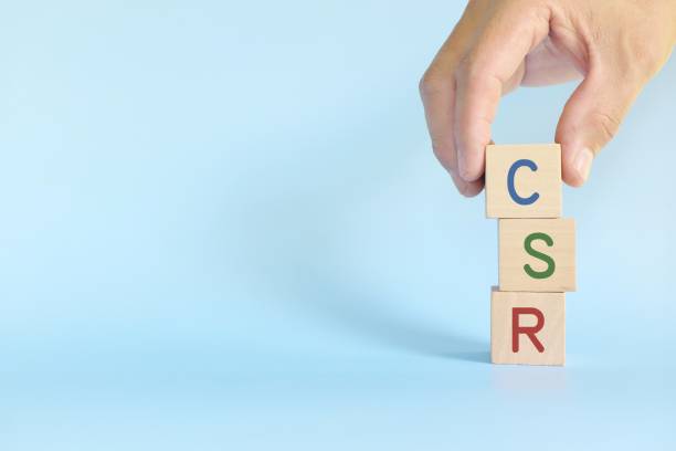 istock Hand stacking CSR or Corporate Social Responsibility in wooden blocks. Support sustainable and responsible business concept. 1359784726