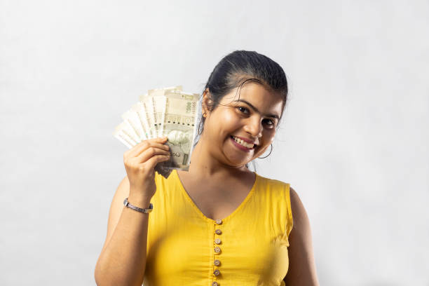 istock Indian woman with money 1359785203