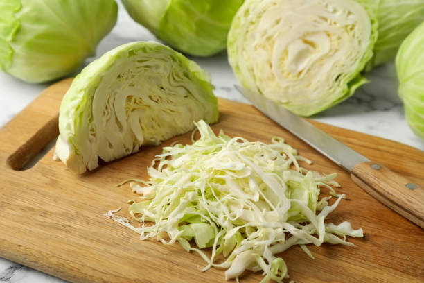 istock Chopped ripe cabbage on wooden board, closeup 1359786944