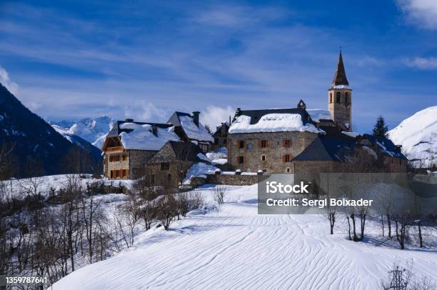 Aran Valley In Winter In The Foreground The Village Of Unha In The Background Aneto Peak With The Maladeta Range Stock Photo - Download Image Now