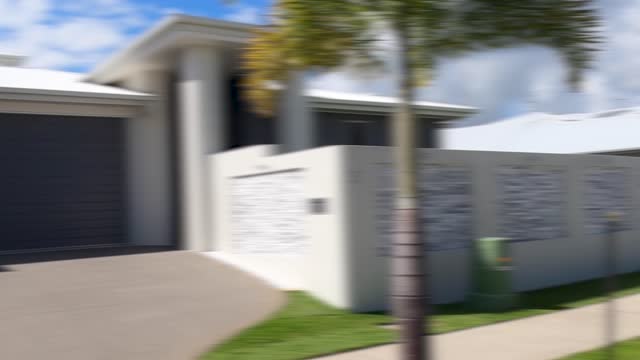 Driving along a street of a generic Australian suburb with modern houses, parked cars, driveways and gardens. Motion blur.