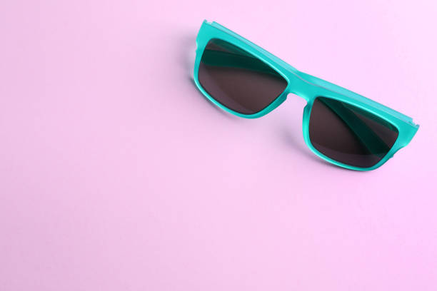 istock Stylish sunglasses on light violet background, top view. Space for text 1359789236