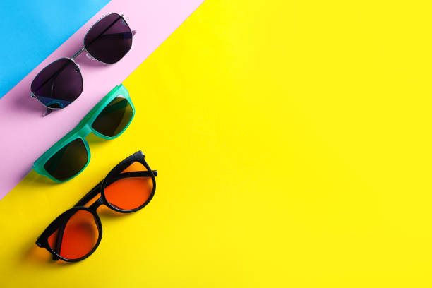 istock Many stylish sunglasses on color background, flat lay. Space for text 1359789423