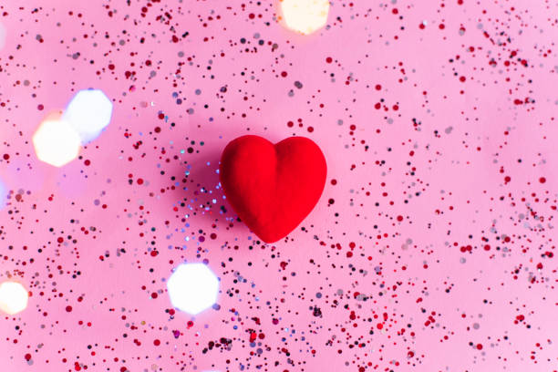 istock Red heart on pink background with confetti. Valentine's Day template 1359790086