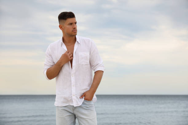 istock Handsome man on beach near sea. Space for text 1359794929