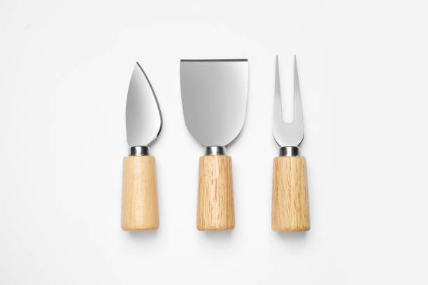 istock Cheese knives and fork on white background, top view 1359795468