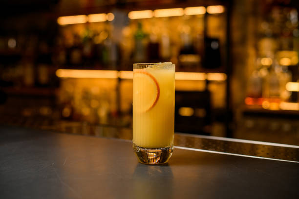 istock glass with cold alcoholic cocktail with orange fruit slices is on bar counter 1359797669