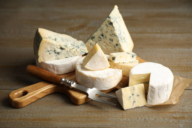 istock Different sorts of cheese and fork on wooden table 1359797861