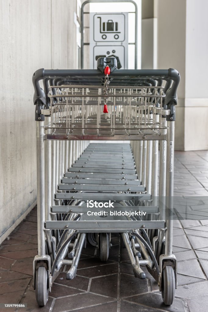 Gepäckwagen am Flughafen Parking space for baggage trolleys at the parking lot of an airport Airplane Stock Photo