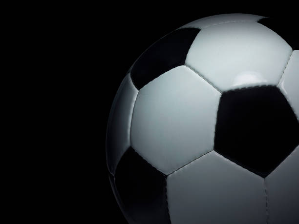 istock Soccer ball on black background 1359802509