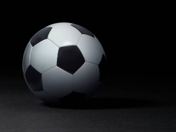 istock Soccer ball on black background 1359803110