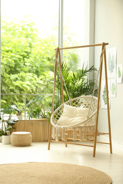 istock Comfortable hammock chair in stylish room. Home interior 1359803300