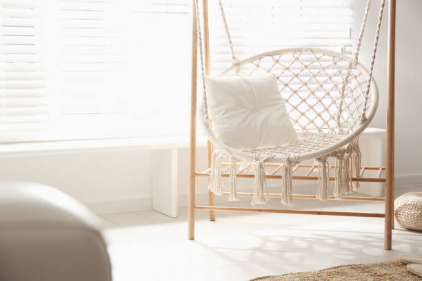 istock Comfortable hammock chair in stylish room. Home interior 1359804038
