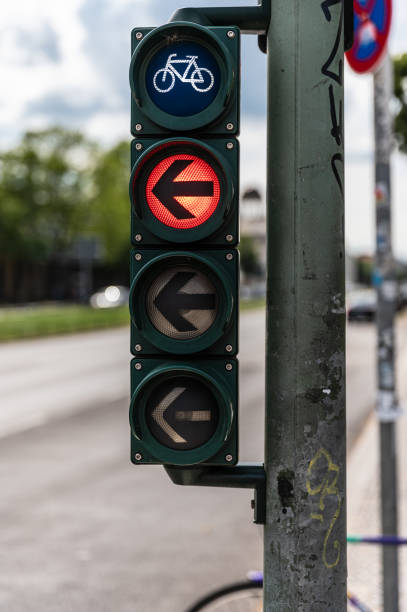 Bicycle traffic light with red arrow to the left Traffic light for cyclists with red direction indicator to the left left wing politics stock pictures, royalty-free photos & images