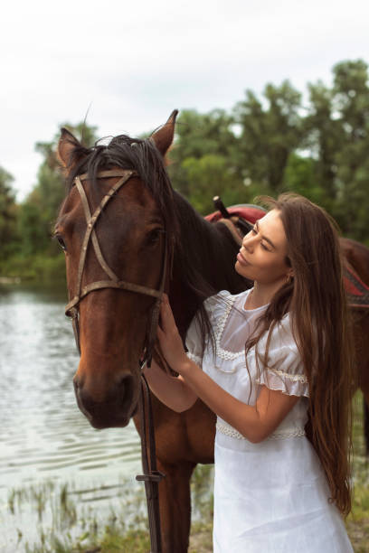 istock Walk with a horse near the river 1359805421