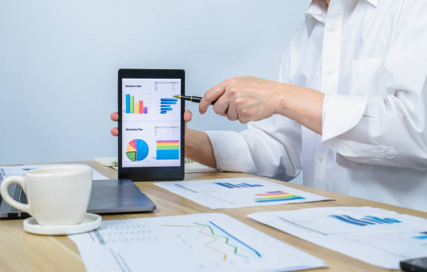 istock executive present business graph on tablet by pen in meeting 1359806057