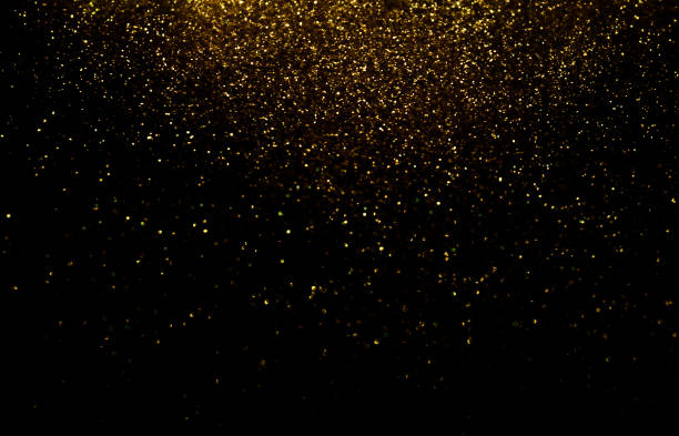 istock Glittery Golden Lights over Dark Background 1359806328