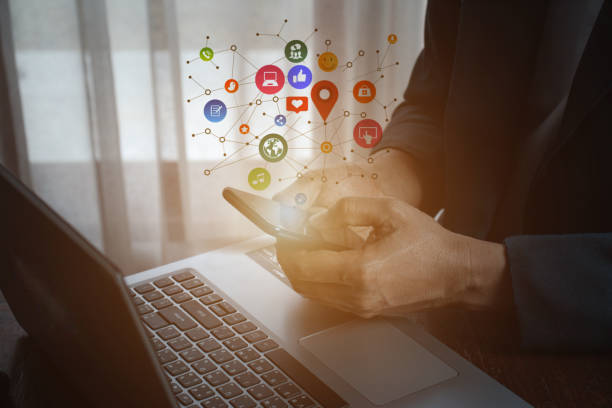 istock man using smartphone with social web icon popup on the phone 1359806604