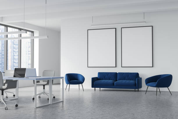 istock Two mockups and accent blue seating area in grey and white office 1359811247