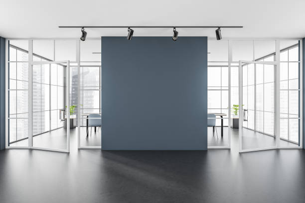 istock Light waiting room behind glass doors, panoramic windows and mockup wall 1359811808