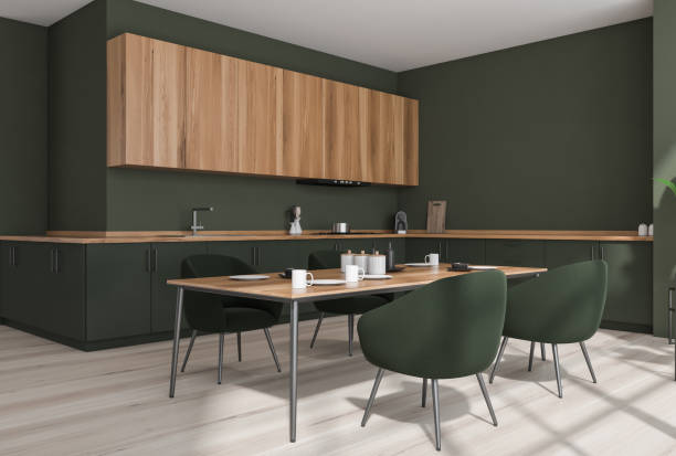 istock Green kitchen interior with table and chairs on parquet floor 1359811845