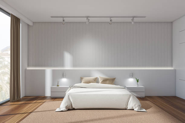 istock White bedroom interior with bed on parquet, nightstand and window 1359811856
