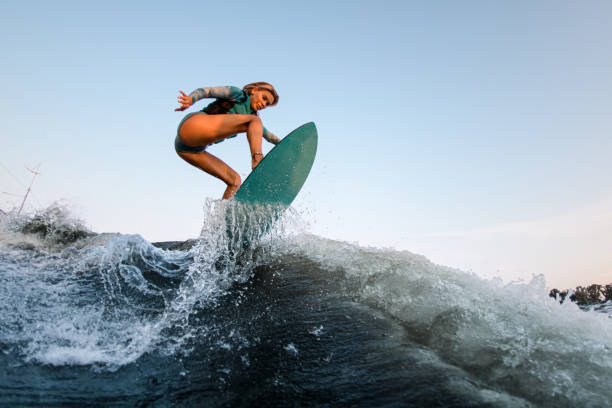 istock active woman wakesurfer skilfully jumping on wakesurf down the river wave 1359811906