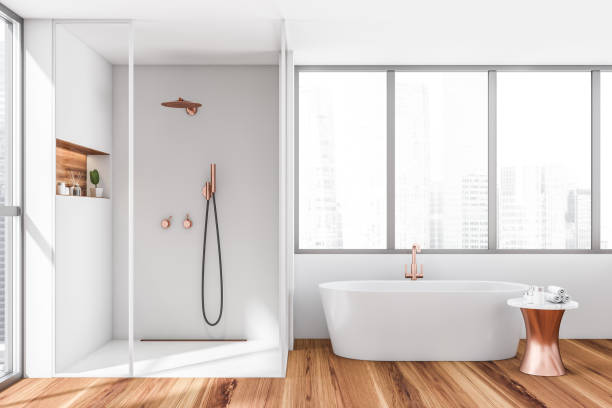 istock Bright bathroom interior with bathtub, shower, panoramic window 1359812720