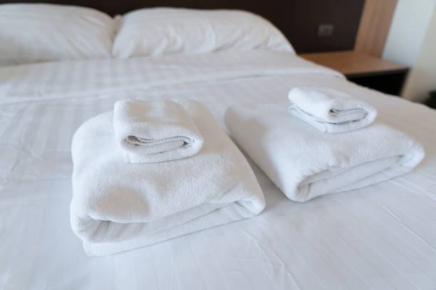 istock Stack towel set on bed in modern bedroom at hotel 1359813634