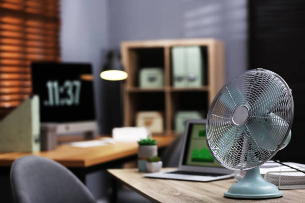 istock Modern electric fan on table in office. Space for text 1359814886