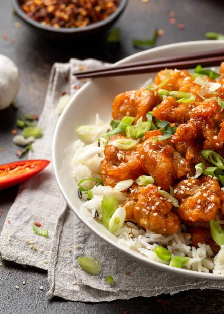 istock Asian crispy sweet sesame chicken with basmati, wild rice and spring onion. 1359815789