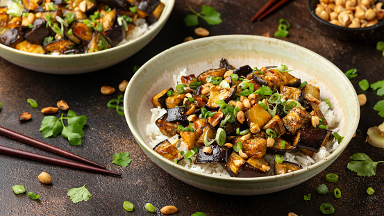 Asian Eggplant with rice, peanuts and spring onion. Healthy food