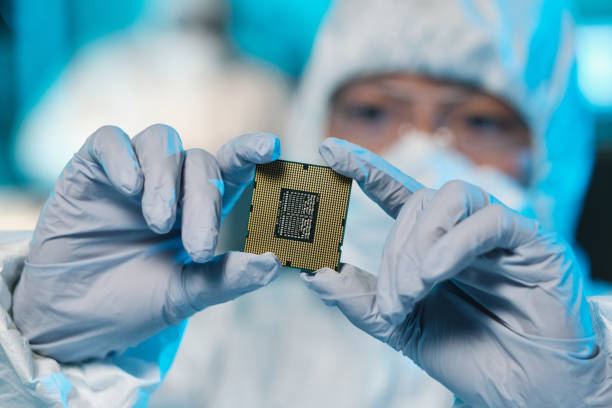 istock Gloved hands of contemporary scientist holding microchip 1359815856