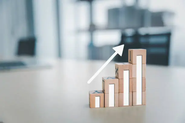 Photo of Business sale performance growth concept, Wooden cube box with graph and rising arrow, Progress improvement concept