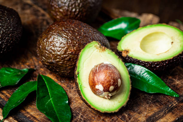 istock Halves of fresh avocado on a cutting board. 1359816982