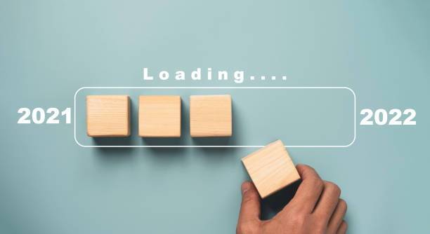 istock Hand putting wooden cube block for downloading progress for countdown 2021 to 2022 on blue background for Merry Christmas and happy new year preparation concept. 1359817785
